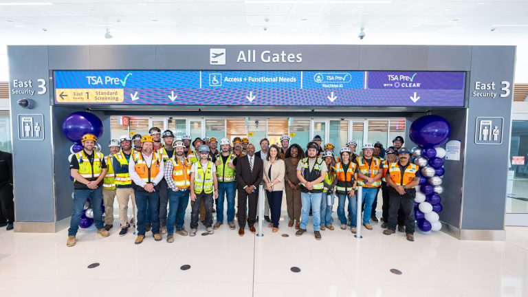 Officials and construction crew gather to celebrate the opening of DEN’s East Security Checkpoint on August 4.