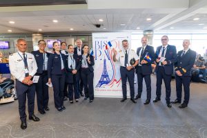 Air France cabin crew posing in front of anniversary banner