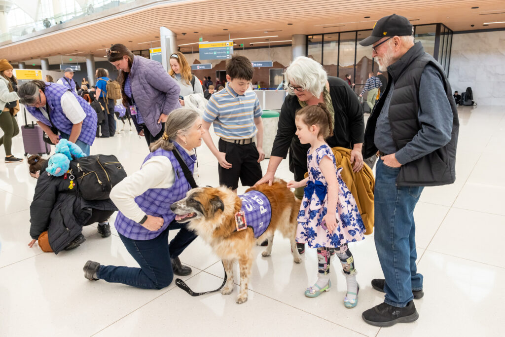 CATS member Spot entertains passengers at DEN.