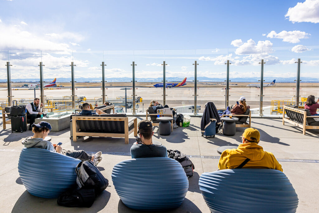 Passengers enjoy the mountain view from the A Gates west patio