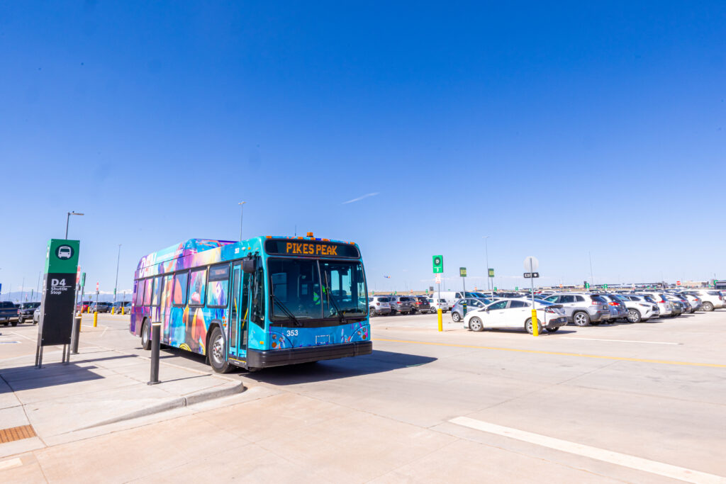 A shuttle bus picks up travelers in the Pikes Peak lot