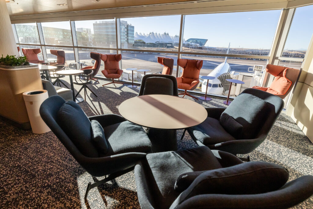 One of the seating sections of the Plaza Premium Lounge with a view of the DEN tents of the airport.